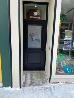 a black door of a store with a sign on it at Downtown Stratford - The Blowes Inn in Stratford