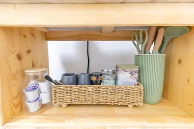a shelf with utensils in a wooden cabinet at Private 2-BR Suite w Patio in Mississauga