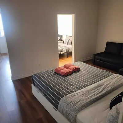 a bedroom with a bed with two red pillows on it at Sweet Home in Bloor Downtown-CENTRAL STAY in Toronto