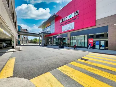 an empty street in front of a shopping center at Chic 2-Bedroom Apartment with Parking in Toronto