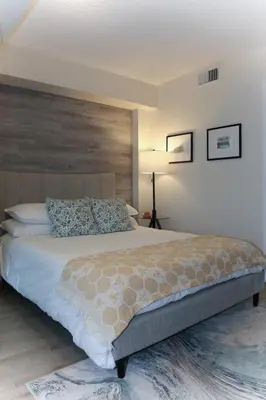 a bedroom with a large bed with a wooden headboard at Cozy Studio in the heart of Yorkville in Toronto