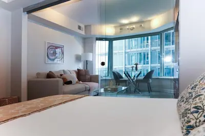 a bedroom with a couch and a living room at Cozy Studio in the heart of Yorkville in Toronto