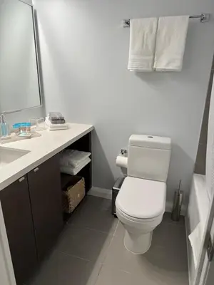 a bathroom with a white toilet and a sink at Cozy Studio in the heart of Yorkville in Toronto