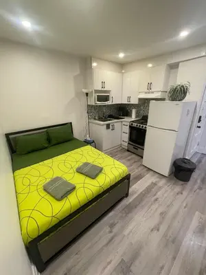 a bedroom with a yellow bed in a kitchen at Exclusive Queen St Downtown Full House-PRIVATE PATIO in Toronto