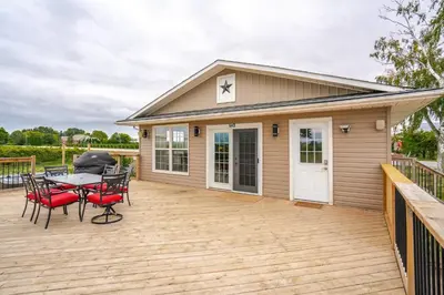 a patio with a table and chairs on a deck at Vineyard 2 Bed Farm Home | Mins to Town & Wineries in Niagara on the Lake