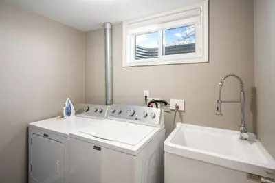 a laundry room with a washing machine and a window at Single Level Vineyard Home | 6 PPL | Pet Friendly in Niagara on the Lake