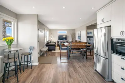 a kitchen and living room with a table and chairs at Single Level Vineyard Home | 6 PPL | Pet Friendly in Niagara on the Lake