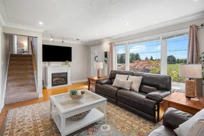 a living room with a leather couch and a fireplace at Vineyard Home Pet Friendly NOTL Large Backyard in Niagara on the Lake