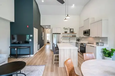 an open kitchen and dining room with a table and chairs at 2 Bdrm Brand New Luxe Niagara Apt - up to 6ppl in Niagara on the Lake