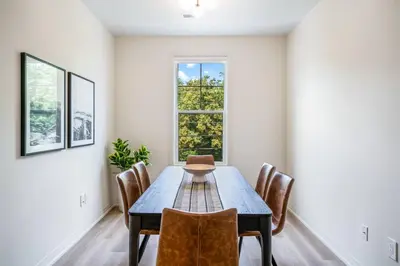 a dining room with a table and chairs and a window at 2 Brdm Modern Brand New Niagara Apt up to 6 ppl in Niagara on the Lake
