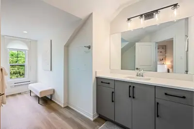 a bathroom with a sink and a mirror at 2 Brdm Modern Brand New Niagara Apt up to 6 ppl in Niagara on the Lake