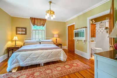 a bedroom with a bed and a television in it at Hot Tub | Mini Putt | Historic Old Town | 2 Guests in Niagara on the Lake