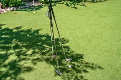 two golf clubs in the shade of a tree at Hot Tub | Historic Home | Steps to Everything NOTL in Niagara on the Lake