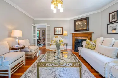 a living room with white furniture and a fireplace at Hot Tub | Heart of Old Town NOTL | 2 Guests in Niagara on the Lake
