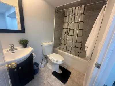 a bathroom with a toilet and a sink and a shower at Cozy Private Two-Level Suite In Brampton With Separate Entrance And Living Area on Main Floor in Brampton