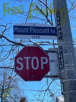 a stop sign on a pole with a street sign at park inn in Toronto