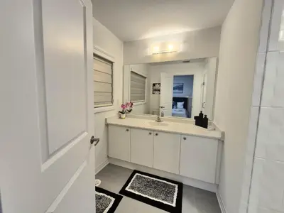 a bathroom with a sink and a mirror at First Class Ensuite Room in Brantford