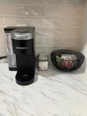 a coffee maker and a basket on a counter at First Class Ensuite Room in Brantford