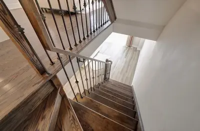 a staircase with wooden floors and a wooden railing at Charming Mississauga Getaway in Mississauga