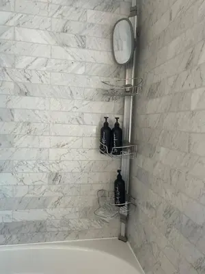 a bathroom with two black bottles on a wall at Cozy Home Away From Home in Kitchener