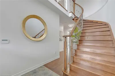 a stairwell with a round mirror and a circular staircase at Tranquil Haven near Niagara in Thorold