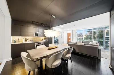 a kitchen and dining room with a table and chairs at Luxury 4BR Home Sleeps 14 with Parking in Toronto