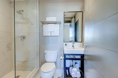 a bathroom with a toilet and a sink and a shower at Dream Suites Near YYZ Airport in Mississauga