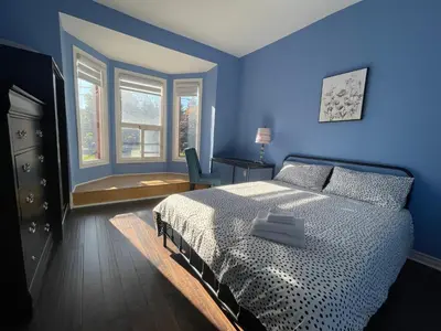 a blue bedroom with a bed and a window at Quiet King Bedroom near DT Toronto in Toronto
