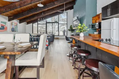 a kitchen and dining room with a table and chairs at 8 Bedroom Blue Mountain Chalet with Ping-Pong - 218 Arlberg in Blue Mountains