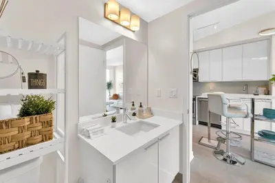 a white kitchen with a sink and a counter at Hidden gem in Humber bay shores Toronto with parking in Toronto