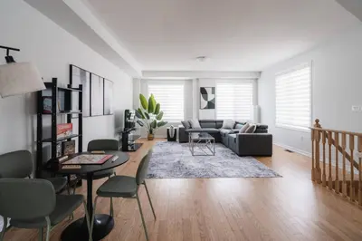 a living room with a couch and a table and chairs at Airport/Family/3bdrm/5beds/4bath/Workspace/Hiking in Brampton