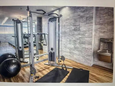 a room with a gym with a treadmill and weights at Elegant and Charm Superior Suite Yorkville Toronto in Toronto
