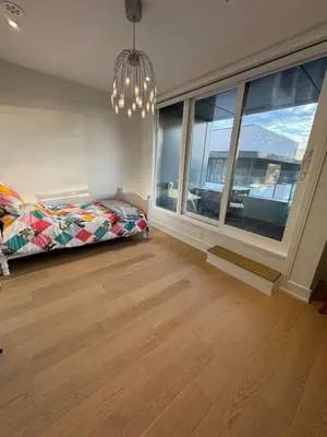 a bedroom with a bed and a large window at Brand New Chic Townhouse in Toronto close to Yonge in Toronto