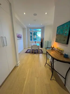 a living room with a table and a dining room at Brand New Chic Townhouse in Toronto close to Yonge in Toronto
