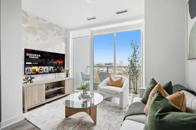 a living room with a couch and a tv at Elegant 2BR Condo with 55 TV & City Views in Toronto