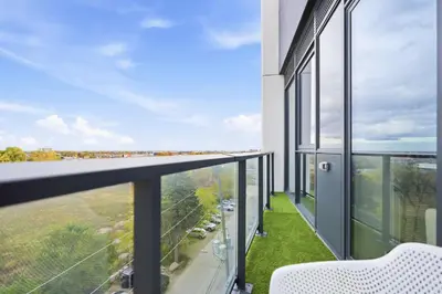a balcony with a view of a city at Elegant 2BR Condo with 55 TV & City Views in Toronto