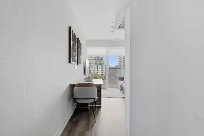a hallway with a table and chairs in a house at Cozy 2BR Condo with Free Parking & City Views in Toronto