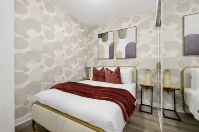 a bedroom with a white bed with red pillows at Cozy 2BR Condo with Free Parking & City Views in Toronto