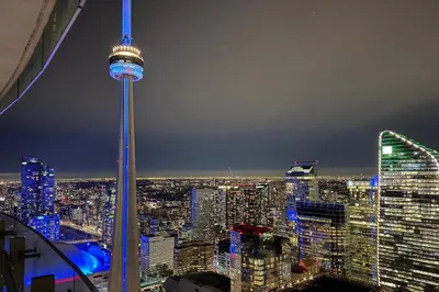 a view of a city at night with the space needle at 60th Floor Luxury SkySuite 3BD Lake & City Views in Toronto
