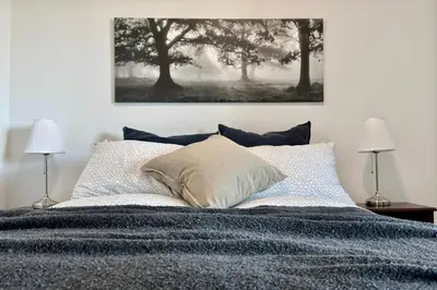 a bedroom with a large bed with two lamps at 60th Floor Luxury SkySuite 3BD Lake & City Views in Toronto
