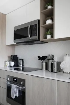 a kitchen with a stove and a microwave at Modern West Getaway 2BR Condo with Free Parking in Toronto