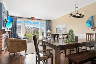 a dining room and living room with a table and chairs at The Sweet Spot - Walk to Village & Hot Tub in Blue Mountains