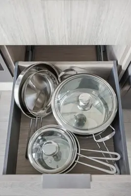 three metal dishes in a drawer of a kitchen at Skyline Studio with Stunning City Views & Parking in Toronto