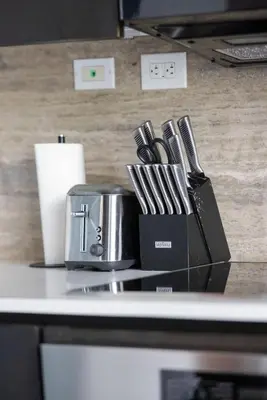 a counter with a container of utensils on it at Modern 4BR Home Sleeps 12 Steps to CN Tower in Toronto
