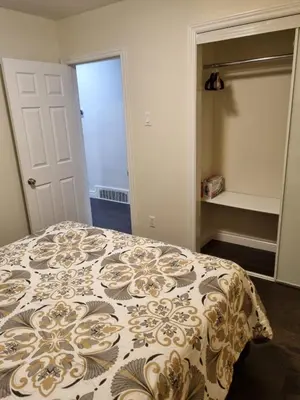 a bedroom with a bed with a comforter on it at Newly Renovated 3BR Upper Unit - Bright & Quiet in Richmond Hill