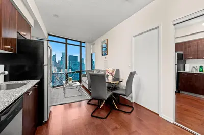 a kitchen and dining room with a table and chairs at High Floor 1 Bedroom Condo City View Downtown Toronto in Toronto
