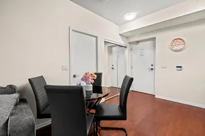 a dining room with a table and black chairs at High Floor 1 Bedroom Condo City View Downtown Toronto in Toronto