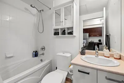 a bathroom with a sink and a toilet and a tub at High Floor 1 Bedroom Condo City View Downtown Toronto in Toronto