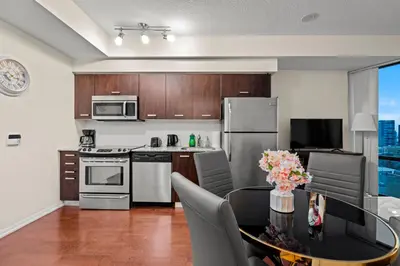 a kitchen with a table with chairs and appliances at High Floor 1 Bedroom Condo City View Downtown Toronto in Toronto