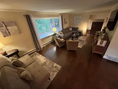 a living room with a couch and a window at Vintage Pines Guest House in Niagara on the Lake